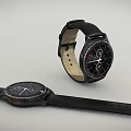 Two Modern Wristwatches With Black Leather Straps And Stylish Dials Displayed In Different Positions