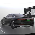 Sleek Black Audi A8L Sedan On Display Platform With Four Rings Logo And Screen