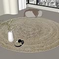 Natural Woven Round Rug in Bright Room with White Vase Greenery and Small Basket