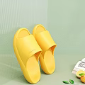 FUSHIA Yellow Slippers Comfortable Slip On Design Soft Rubber Material Against Green Wall And Table