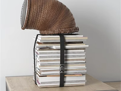 Stacked Books Tied with Black Belt and Woven Basket on Wooden Table 3d model