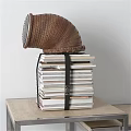 Stacked Books Tied with Black Belt and Woven Basket on Wooden Table