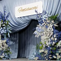 Elegant Photo Spot With Light Blue Arch Curtains And Blue White Floral Decorations