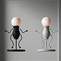 Humanoid Shaped Table Lamp In Black And Gray With Round Base And White Bulb