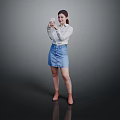 A Woman Wearing White Shirt And Blue Denim Skirt Using Smartphone Against Gray Reflective Floor