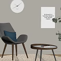 Gray Accent Chair With Blue Cushion Round Wooden Side Table Art Print And Potted Plant