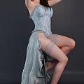 Woman In Blue Lace Corset With Sheer Skirt And Stockings Posing Gracefully