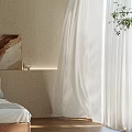 Cozy Bedroom Interior With Beige Wall White Sheer Curtains Artwork And Green Plant