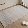 Light Gray Square Rug on Herringbone Wooden Floor with Open Book and Window Blinds