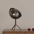 Stylish Silver Table Lamp with Hemispherical Perforated Shade and Tripod Metal Stand on Wooden Desk