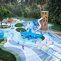 Outdoor Children's Playground with Slide Blue Water Features Play Structures and Green Trees