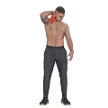A Shirtless Man Wiping Shoulder With Orange Cloth In Dark Pants And Black Shoes