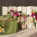 Elegant Floral Arrangement With Green Folding Screen And Wicker Decorations On Green Tablecloth