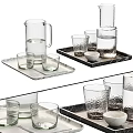 Assorted Glass Drinkware With Carafes On Marble Trays