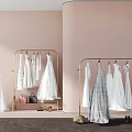 Elegant White Wedding Dresses on Gold Hangers with Pink Background and Accessories