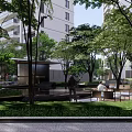 Modern Residential Landscape With High Rise Buildings Lush Green Trees And Pedestrian Walkways