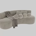 Beige Textured Two Seater Sofa With Striped Throw Blanket And Matching Round Pillows
