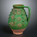 Ancient Ceramic Jug With Green Glaze Bulbous Decorations Circular Patterns And Terracotta Base