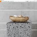 Fresh Eggs in a Straw Nest on a Speckled Gray Stone Pedestal Against Gray Wall