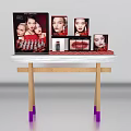 Organized Dressing Table With Makeup Products And Display Images On White Top