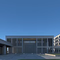 Modern School Building With Glass Facade Symmetrical Structure And Open Plaza Under Blue Sky