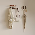 Wall Hanging Setup With White Handbag Coat And Umbrella On Beige Wall Hooks