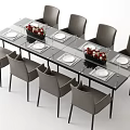 Modern Dining Table Set With Glass Top Eight Grey Chairs Floral Centerpieces And White Plates