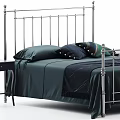 Double Bed With Metal Frame Tall Posts Dark Green Sheets And Decorative Pillows 3d model