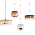 Modern Multiple Pendant Lights With Transparent Brown Glass Shades And Golden Metal Accents