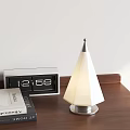 Cone Shaped Table Lamp With White Lampshade Silver Base On Wooden Desktop And Digital Clock