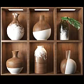 Stylish Ceramic Vases Arranged on Wooden Shelf with Brown White Patterns and Green Leaf