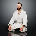 Man In White Judo Uniform Sitting Cross Legged On Dark Background With Beard