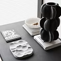 Black Inflatable Multi Layer Vase With White Wave Tray And Books On Table