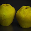 Two Fresh Yellow Fruits with Smooth Surface and Natural Spots on Dark Background