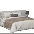 Double Bed with Grey Headboard White Sheets Brown Blanket Pillows and Side Table Lamp