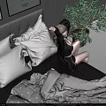 A Woman Sitting On Bed With Framed Posters Gray Wall Floor Lamp And Potted Plant