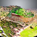 Vibrant Natural Terrain With Green Vegetation Rocky Outcrops And Varied Landforms