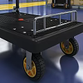 Black Platform Cart With Metal Handle And Yellow Hub Wheels In Warehouse