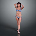 Woman in Blue Bikini Standing with Hands on Head Against Gray Background