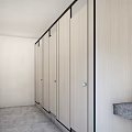 Public Toilet With Light Colored Stalls Black Frames And Modern Clean Design