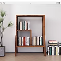 Wooden Open Bookcase With Books On Multiple Shelves And Potted Plant On Wooden Floor