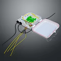 Computer Circuit Board In Transparent Case With Green Components White Cover And Colored Wires