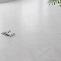Modern White Marble Floor Tiles in Bright Living Space with Open Book and Green Plant