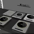 Modern Kitchen Appliances Showcasing Multiple Induction Cooktops On Black Countertop With Gray Wall