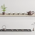 Traditional Tea Set with Teapot and Cups on Bamboo Mat and Decorative Plant