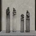 Traditional Stone Pillars With Carved Figures And Intricate Ornate Details