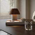 Modern Table Lamp On Desk With Window Blinds Books Glass And Stone Decoration