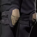 Man In Tactical Vest With Knee Pads Holding Pistol