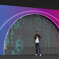 Event Entrance with Arched Purple Blue Neon Lights and Digital Code Backdrop Person Takes