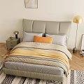 Modern Double Bed with Gray Upholstered Headboard Gray Orange Pillows Yellow Blanket and Floor Lamp